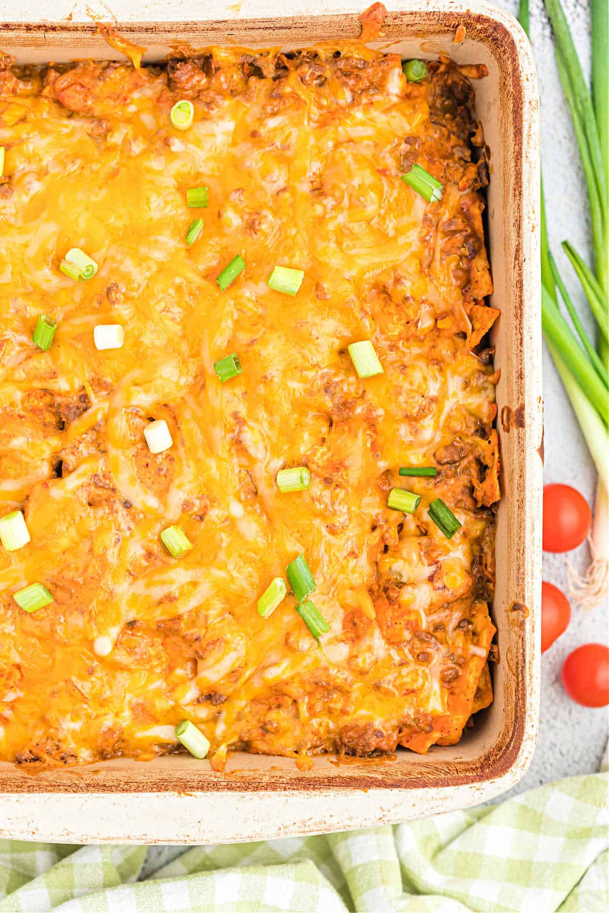 Dorito casserole baked in a square dish.