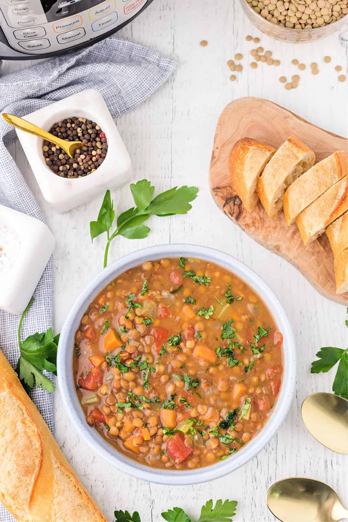 Lentil soup served in a white bowl.