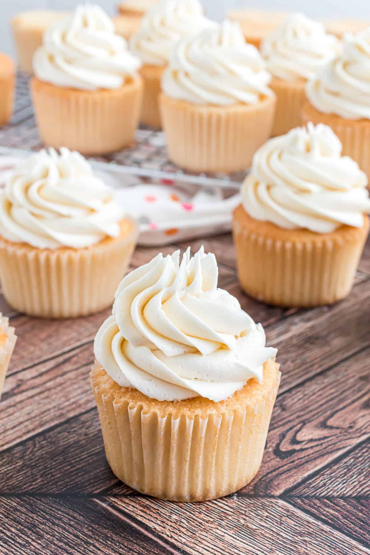 White cupcakes topped with vanilla frosting.