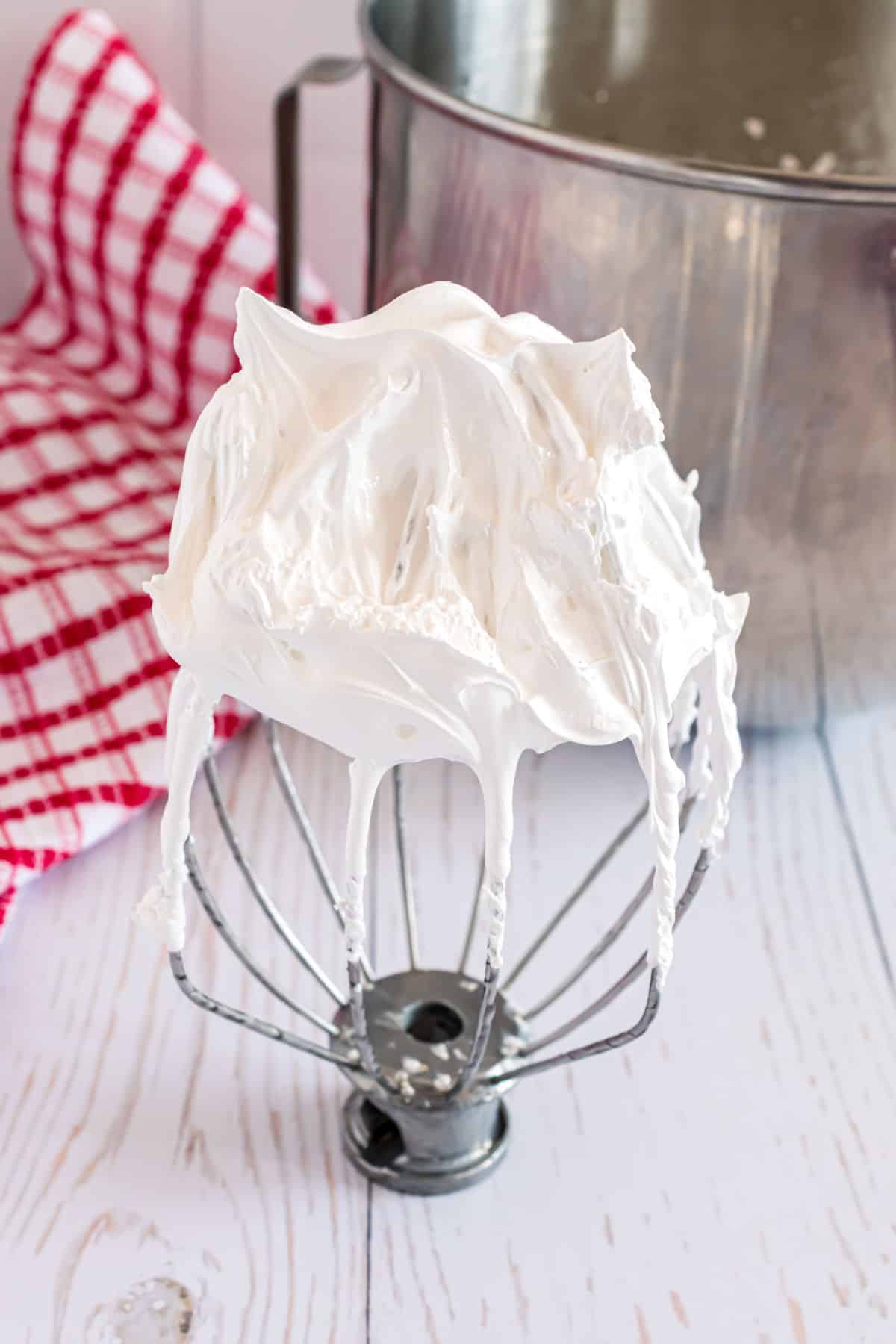 Homemade marshmallow cream on a whisk.