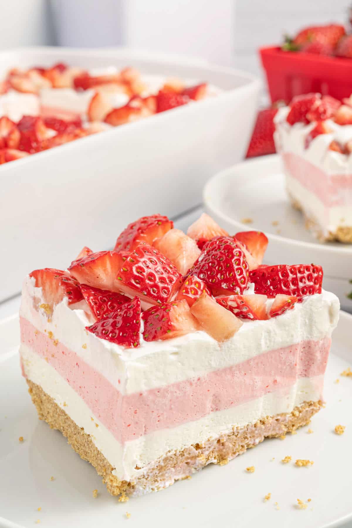 Slice of no bake layered strawberry dessert.