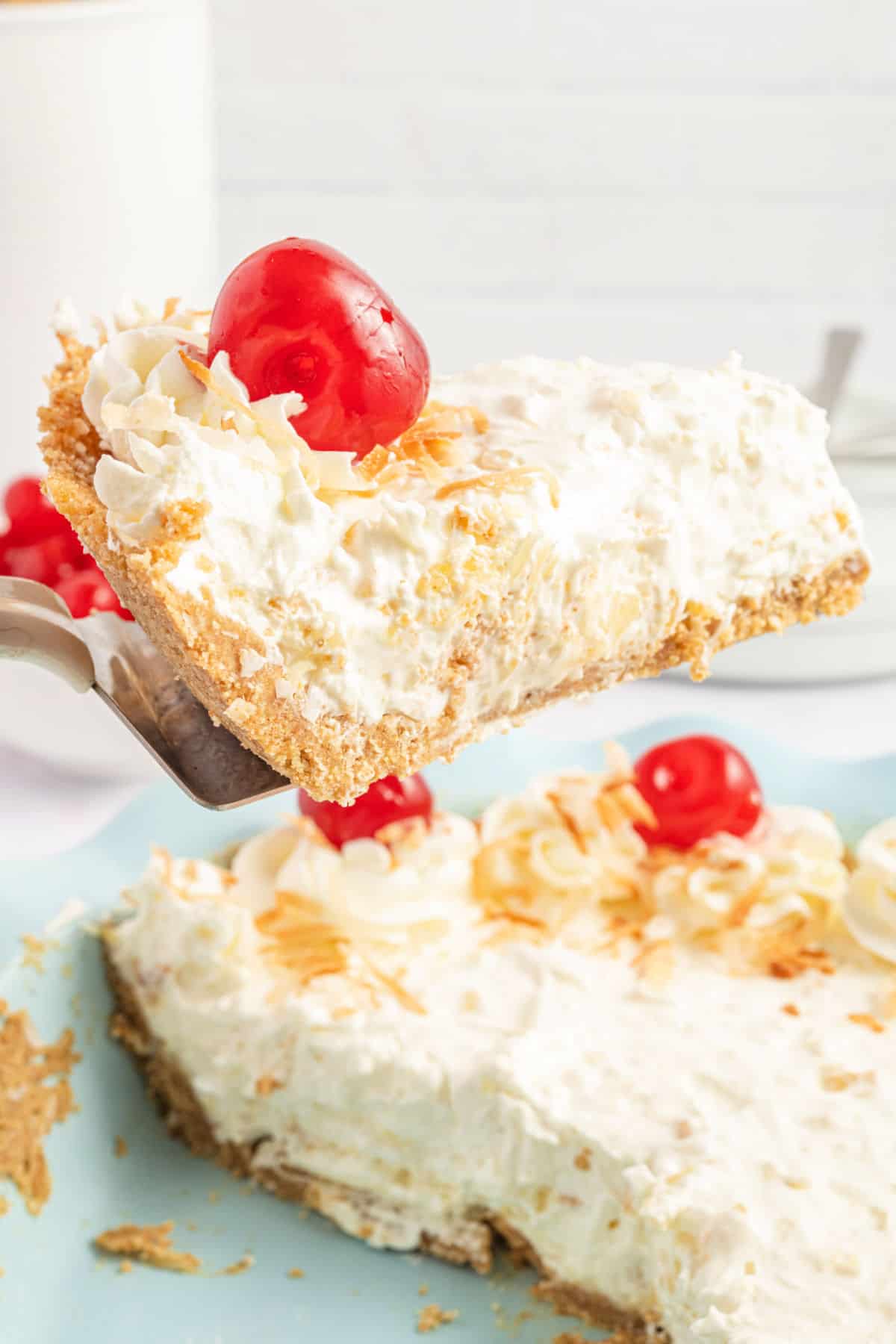 Pineapple pie slice being lifted out of dish with spatula.