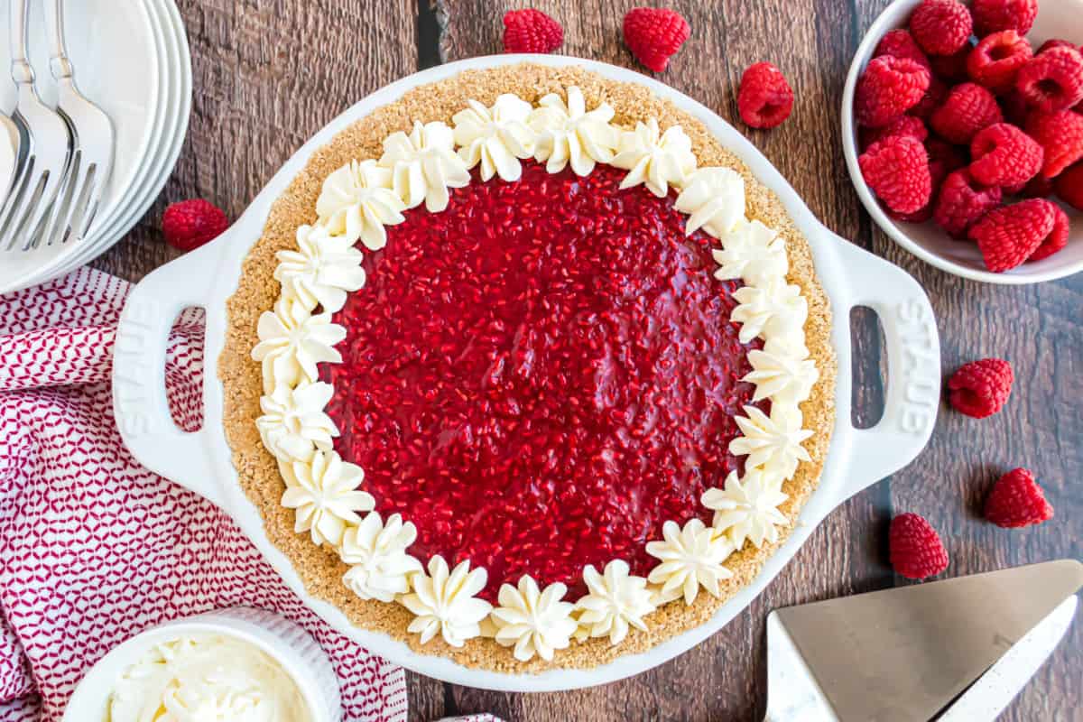 No bake raspberry cheesecake in a white pie plate.