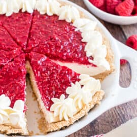 This easy No Bake Raspberry Cheesecake is a beautiful and delicious dessert with a graham cracker crust, creamy, luscious filling and tons of fresh raspberry flavor in the topping!