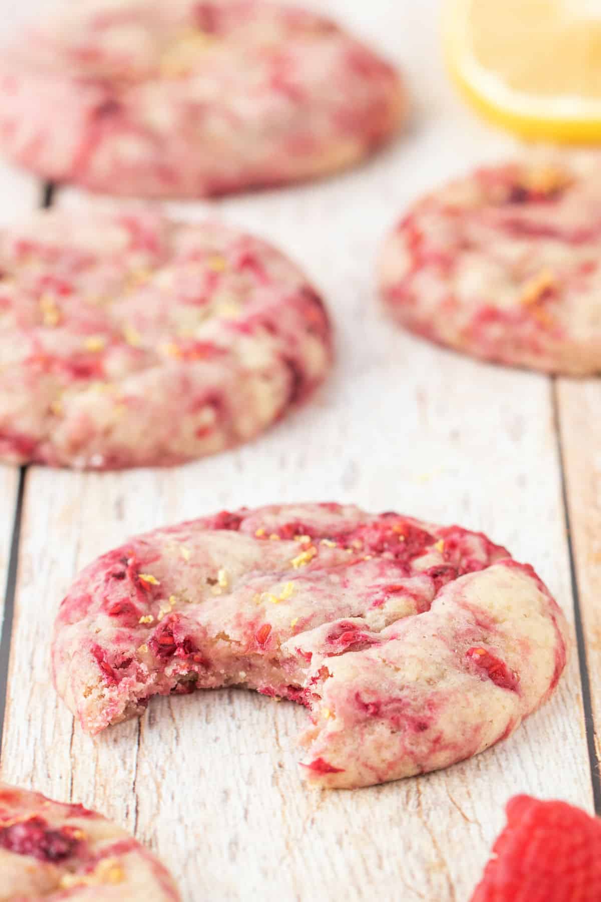 Raspberry cookie with a bite taken out.
