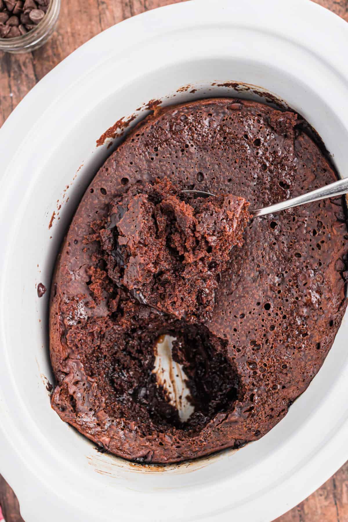 Hot fudge cake cooked in a white slow cooker.