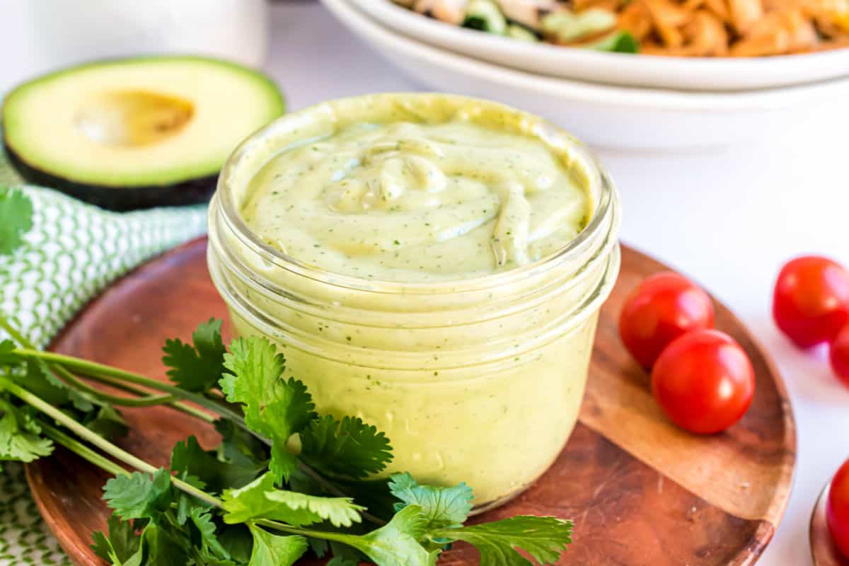 Avocado dressing in a small glass jar.