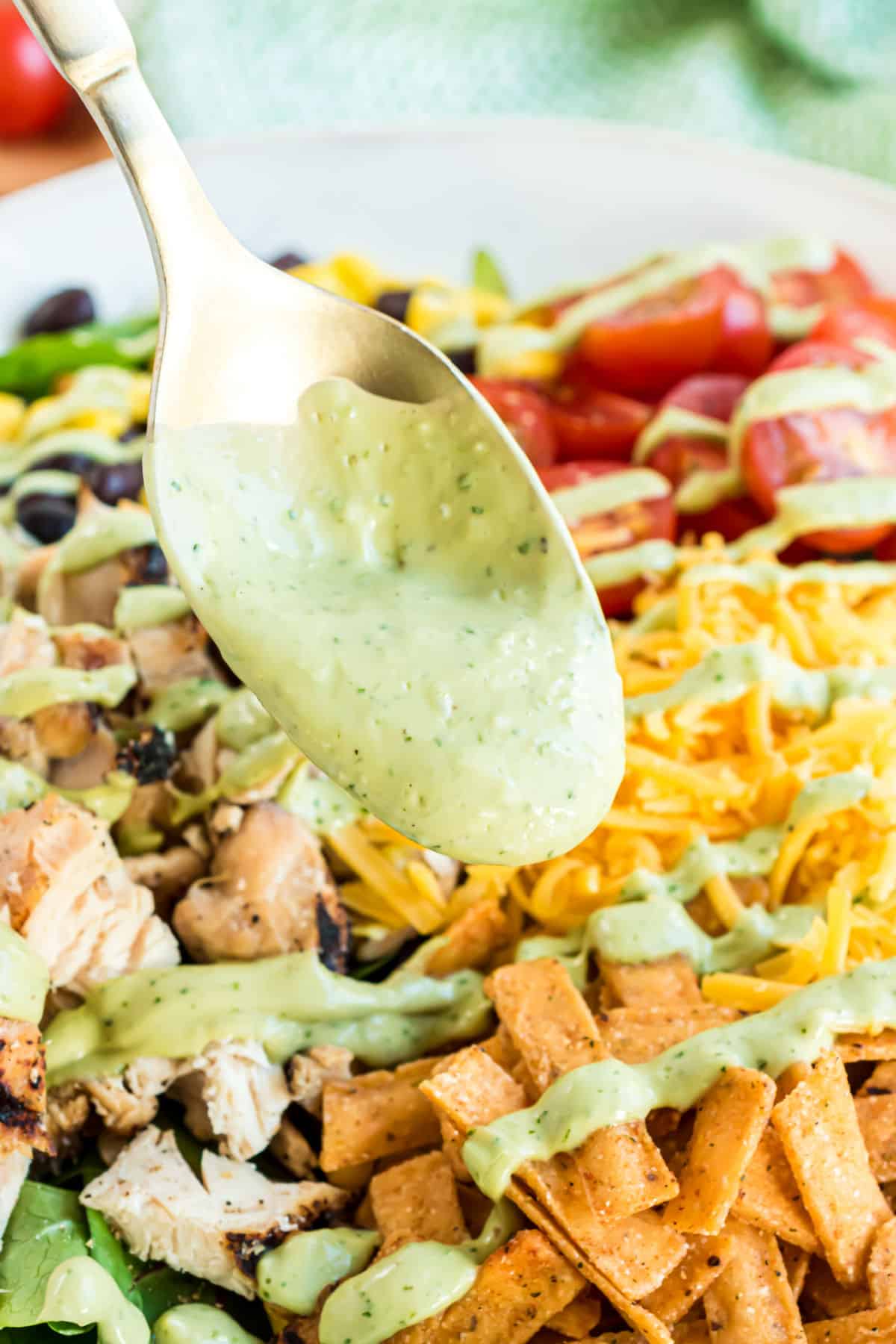 Avocado salad dressing drizzled over a southwest chicken salad.