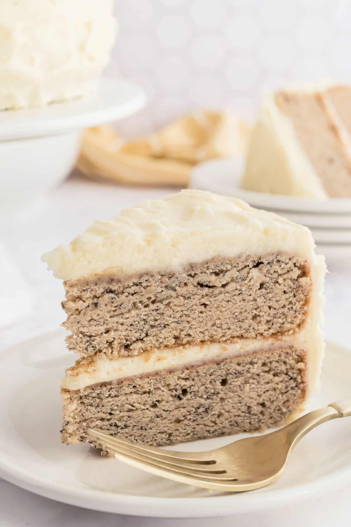 Slice of banana cake on a white plate.