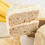 Slice of banana cake with cream cheese frosting.