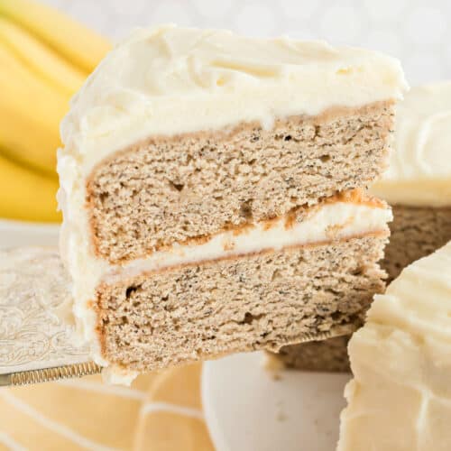 Slice of banana cake with cream cheese frosting.