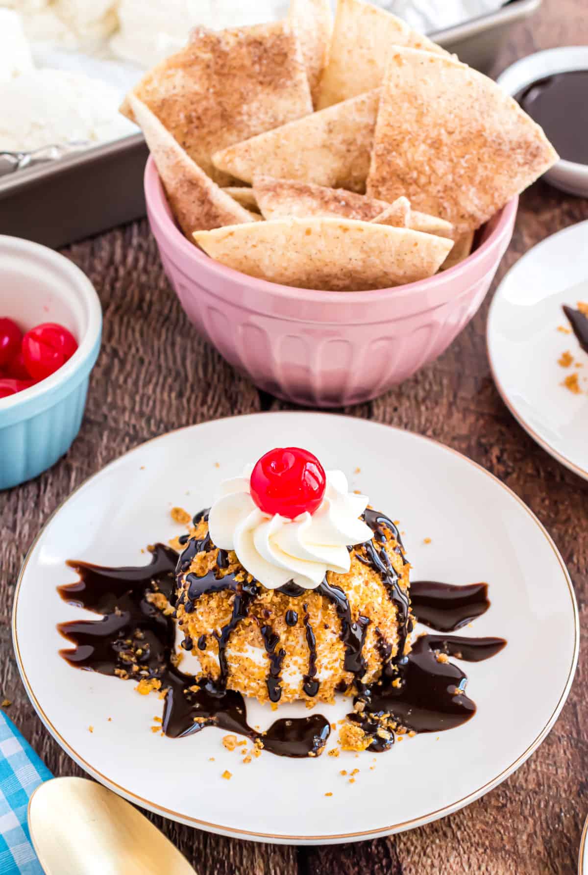 Fried ice cream served on a white plate with a side of cinnamon tortilla chips.