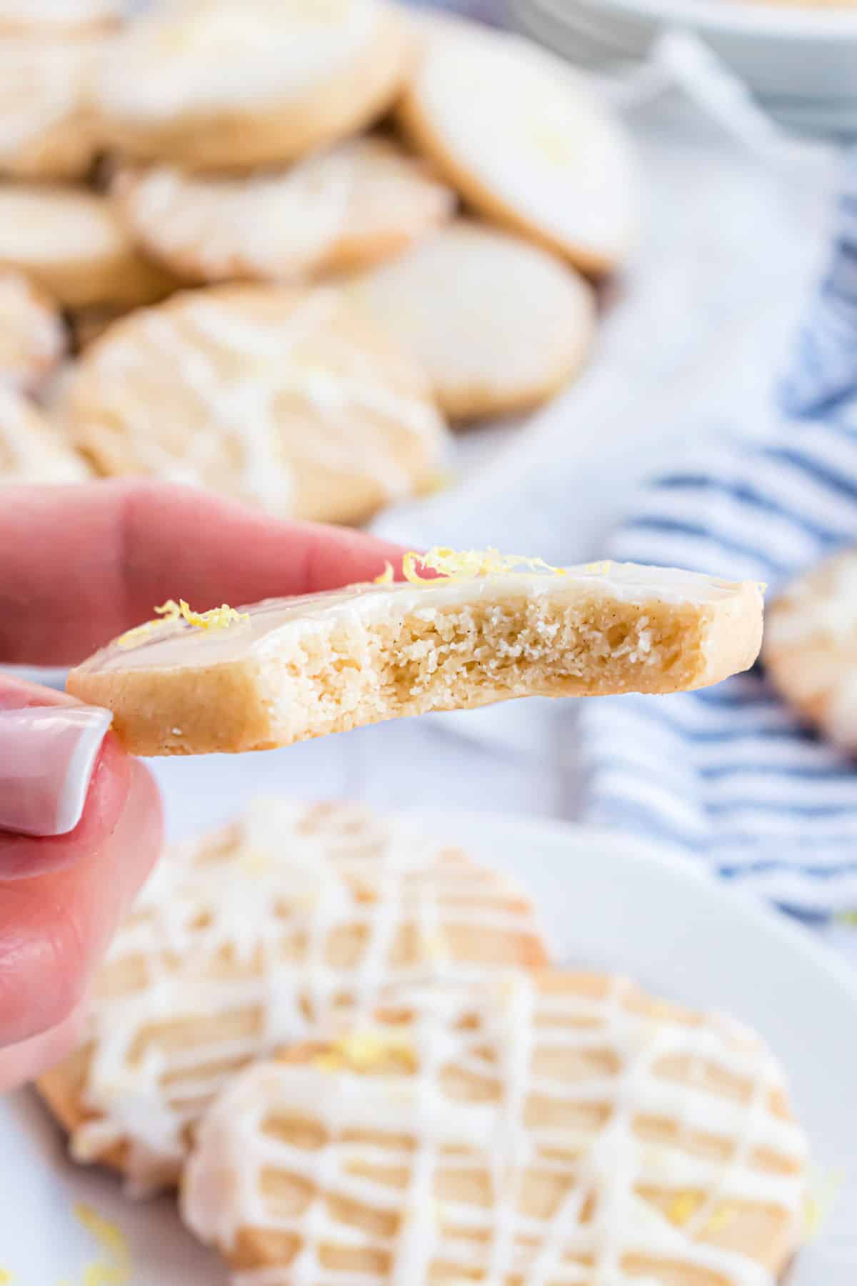 Bite taken out of a lemon shortbread cookie.