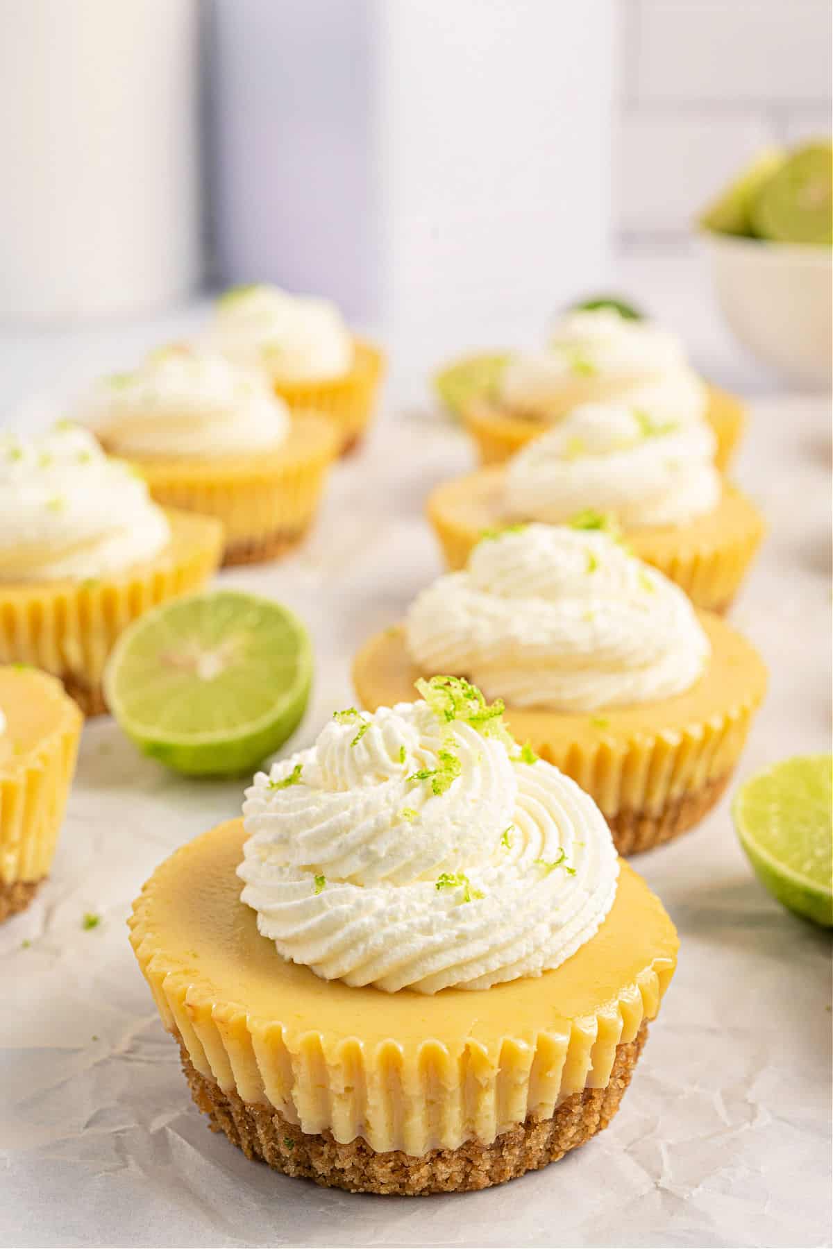 Individual key lime pies with whipped cream on top.