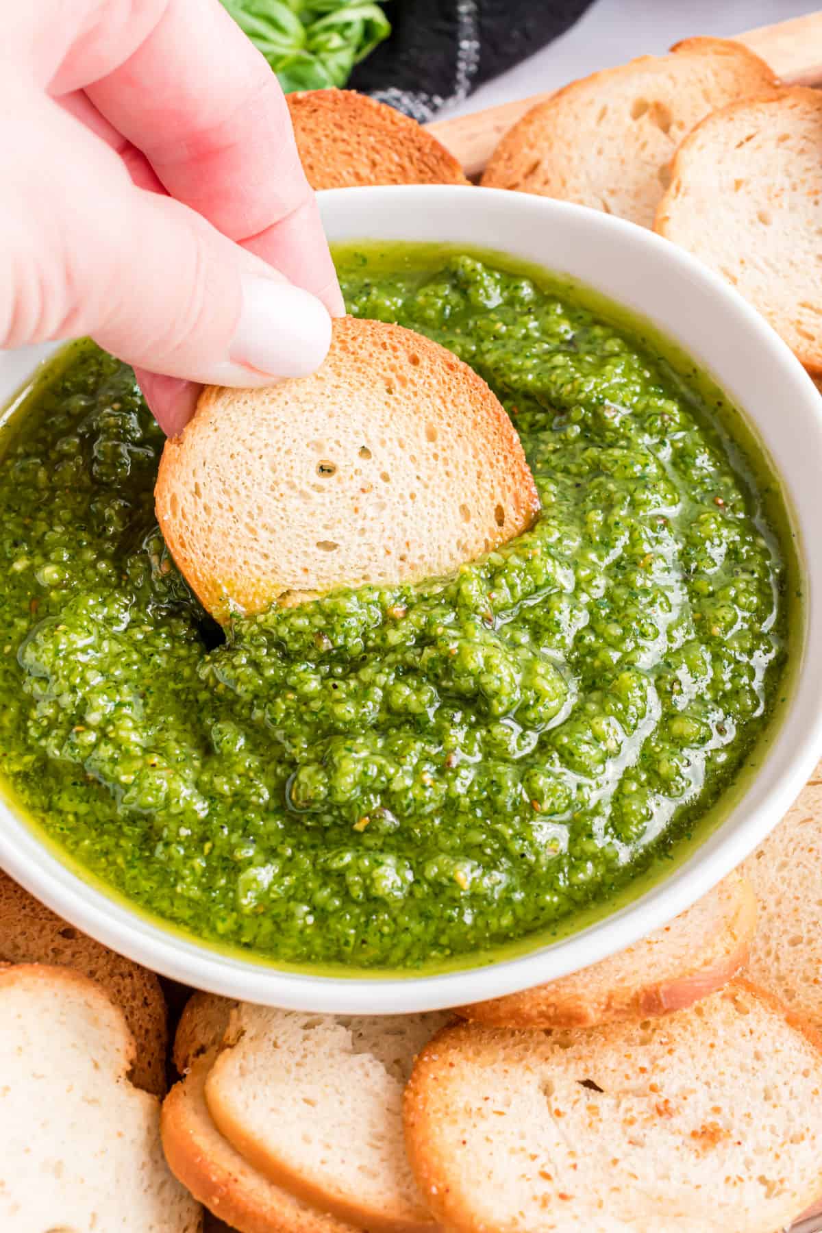 Basil pesto with a bagel chip dipper.
