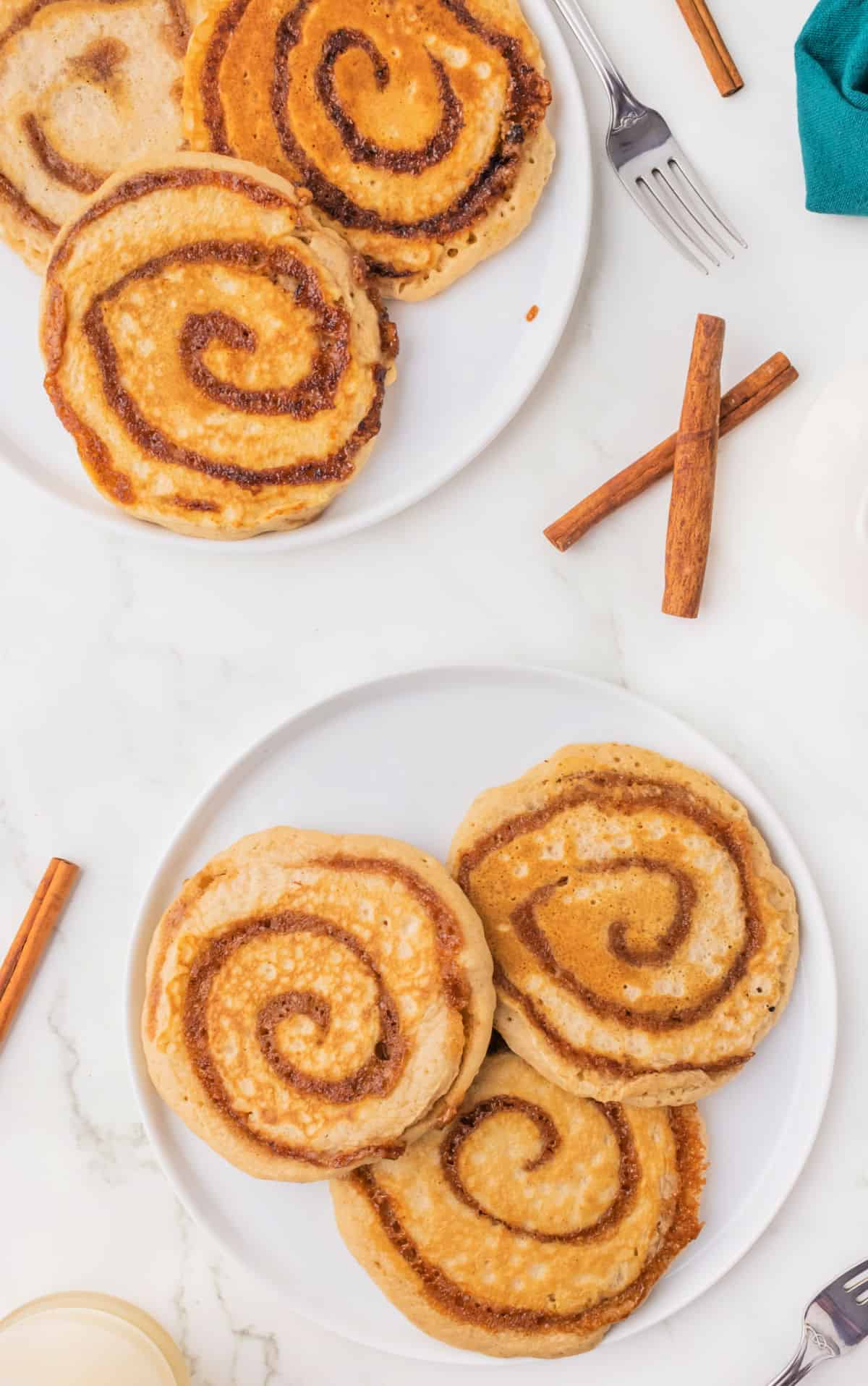 Plates of cinnamon swirled pancakes.