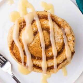 Cinnamon Roll Pancakes are the perfect excuse to have dessert for breakfast. Just serve up these fluffy pancakes with a swirl of buttery cinnamon sugar and syrup drizzled on top. Yum!