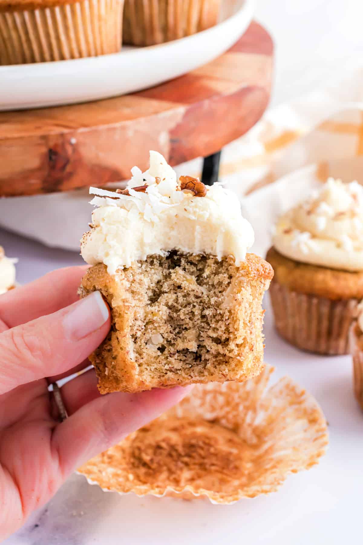 A bite taken out of a hummingbird cupcake.