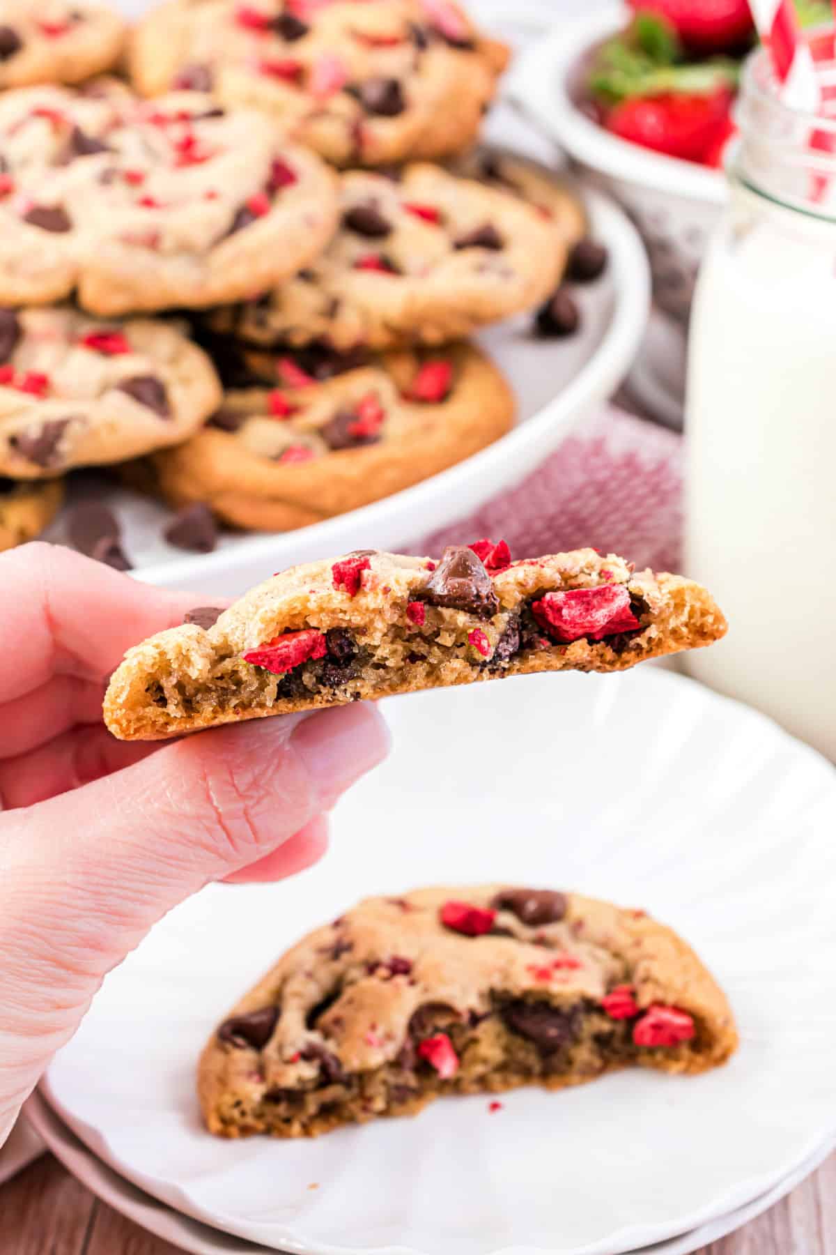 Strawberry cookie with a bite taken out.
