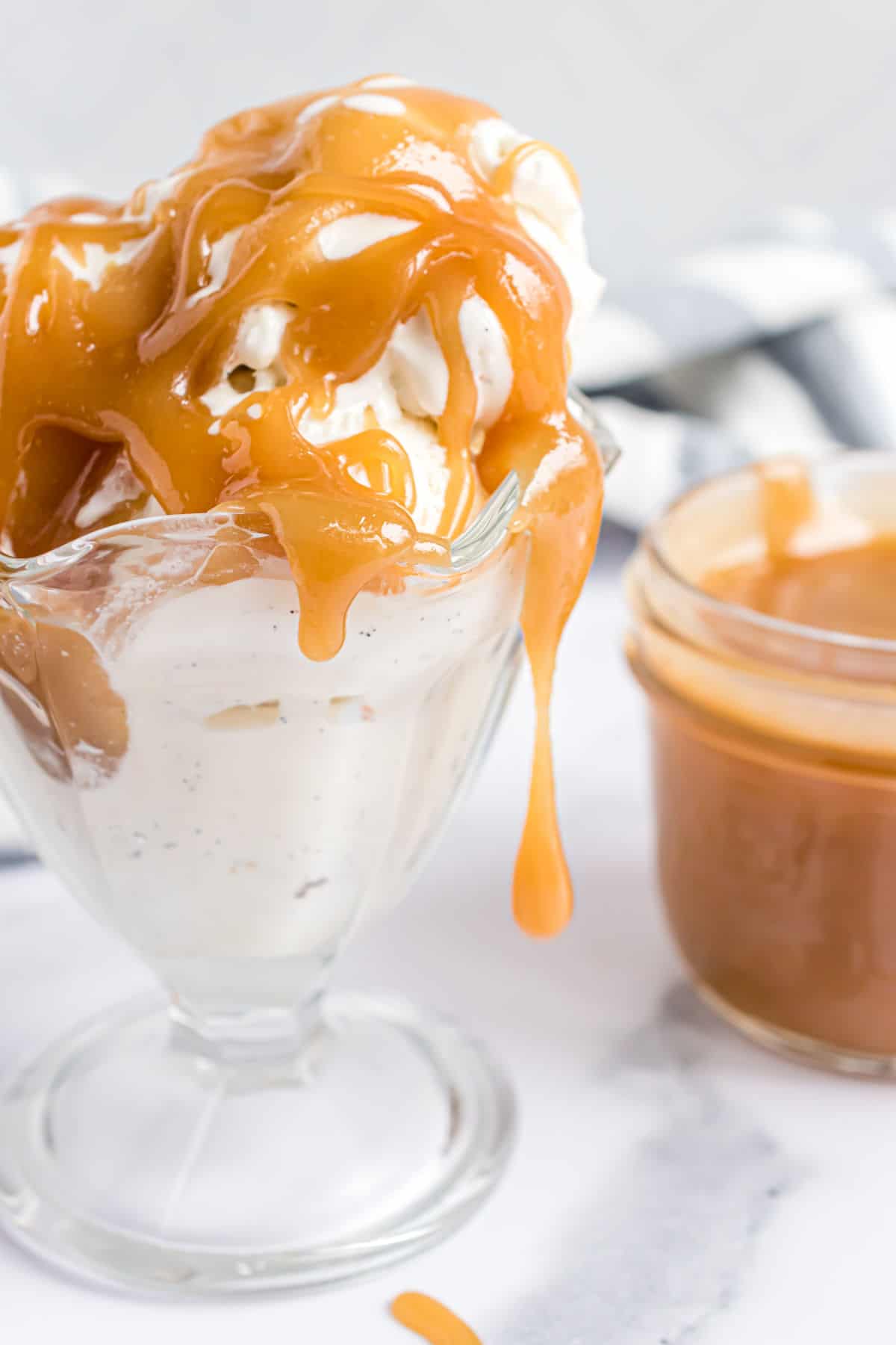 Butterscotch sauce dripping off an ice cream sundae.