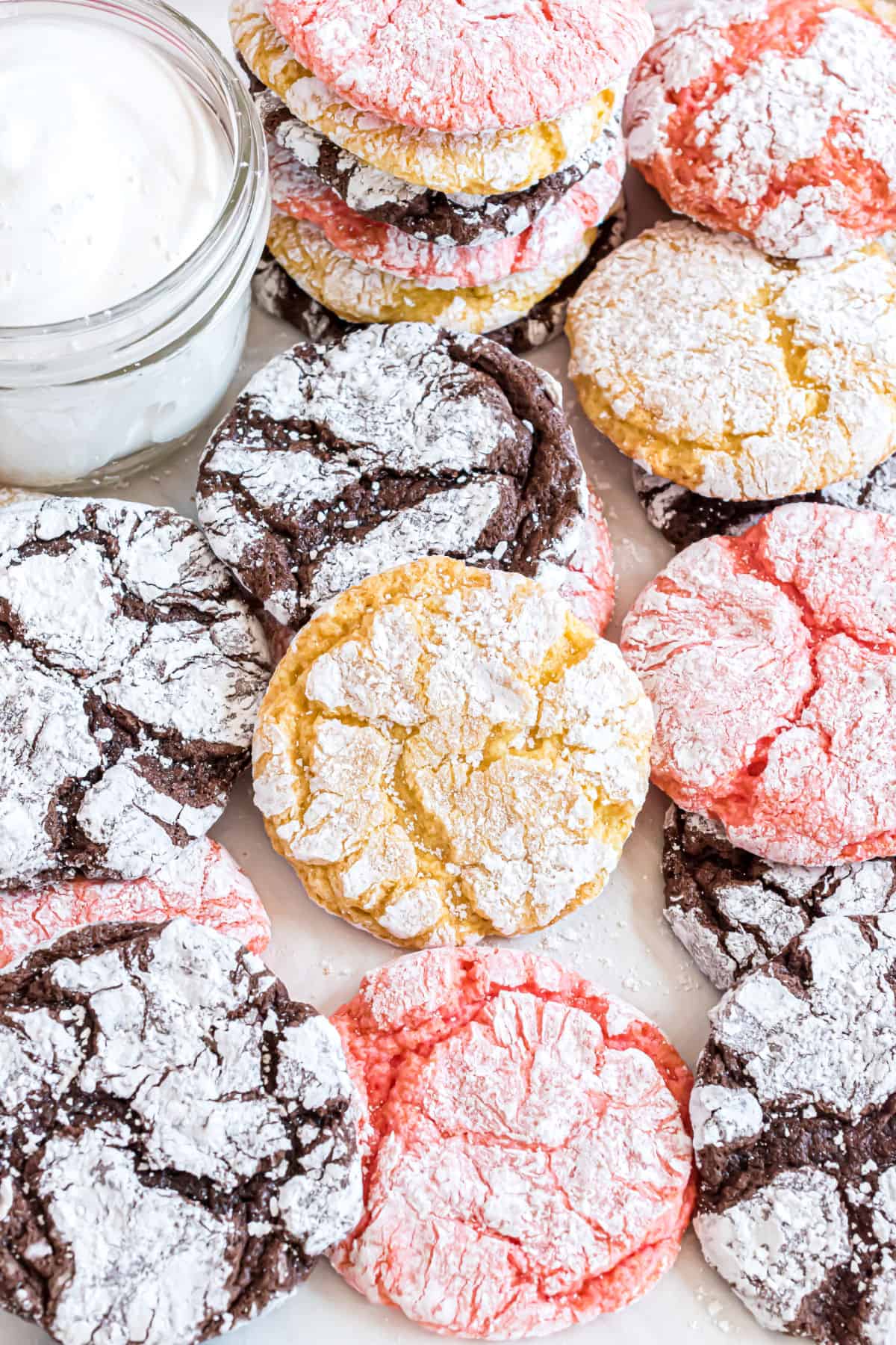 Cool whip cookies stacked on parchment paper.