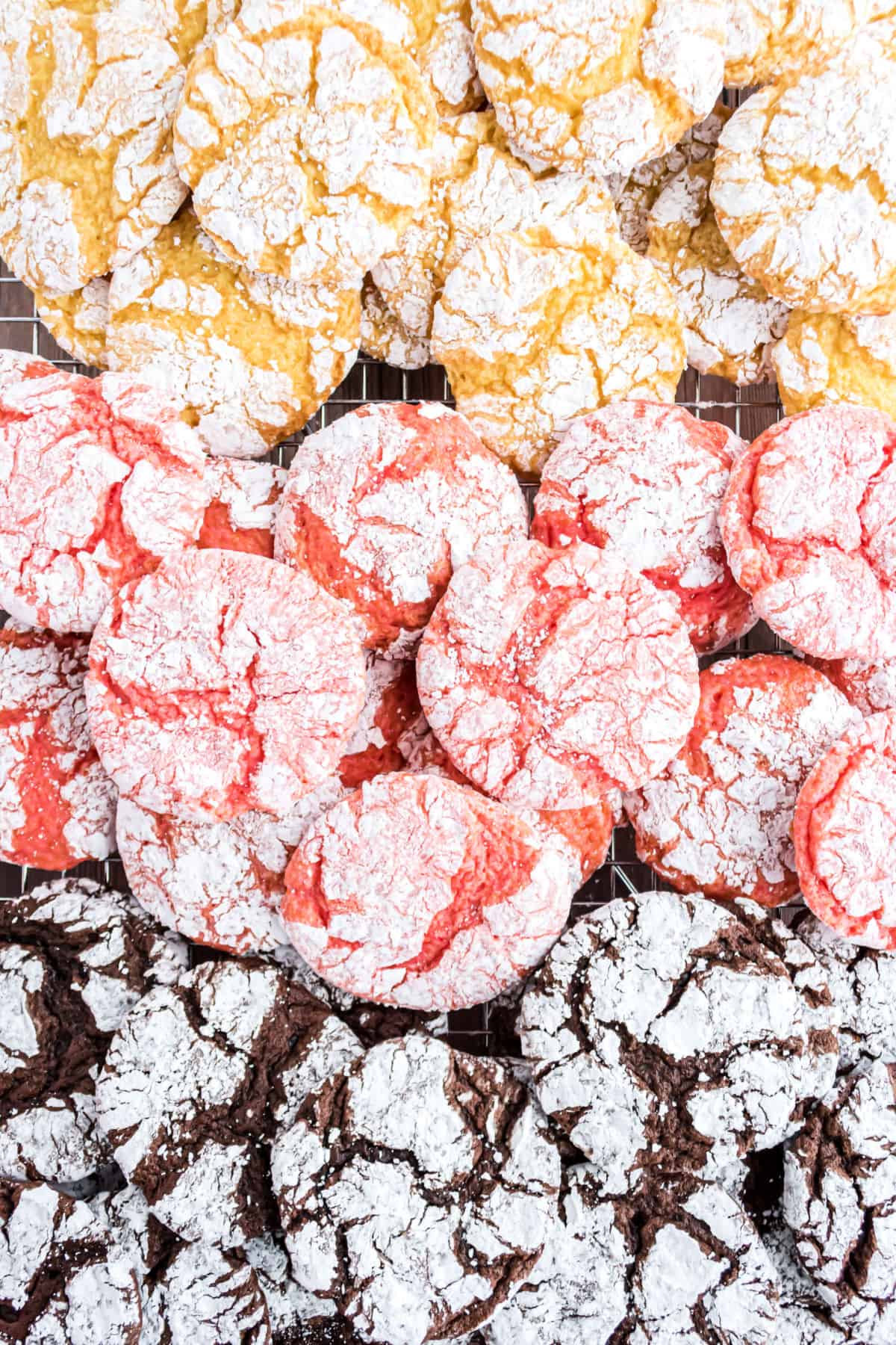 Lemon, Strawberry, and Chocolate crinkle cookies stacked.