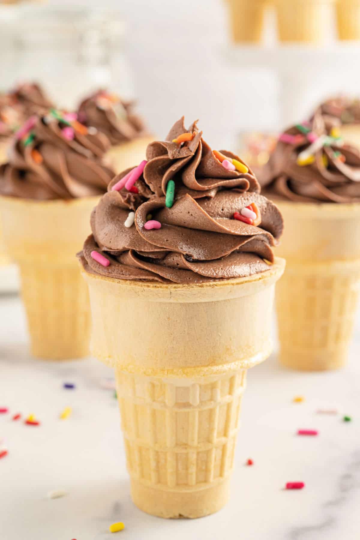 Cupcake baked inside an ice cream cone and topped with chocolate frosting.