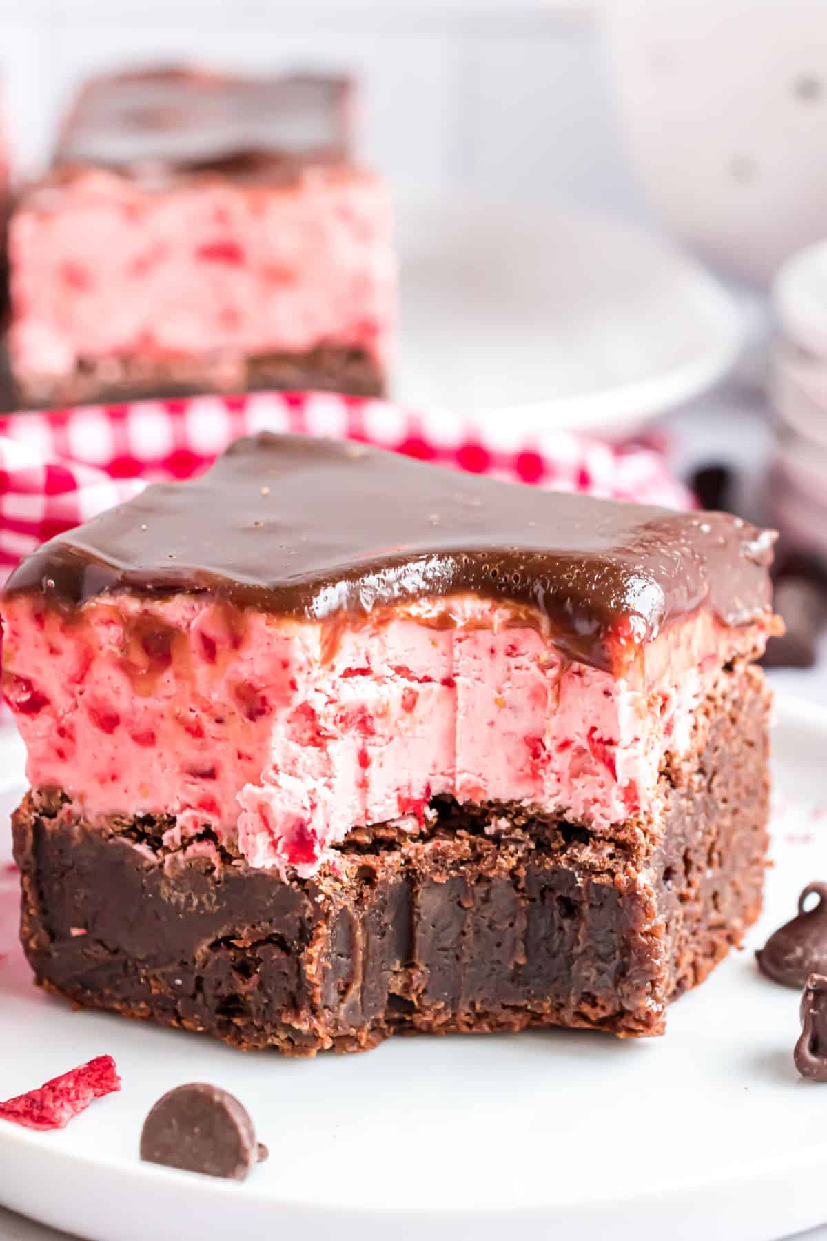 Brownie with strawberry frosting and a bite taken out.