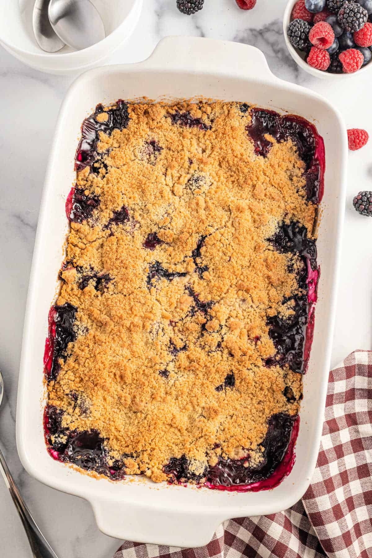 Berry crumble baked in a white baking dish.