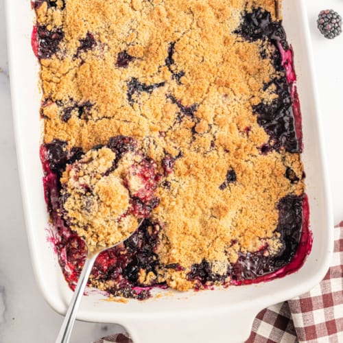 This Berry Crumble recipe has all the satisfaction of a mixed berry pie but none of the effort. A sweet berry filling topped with a generous layer of crumble that is crunchy and crumbly at the same time.
