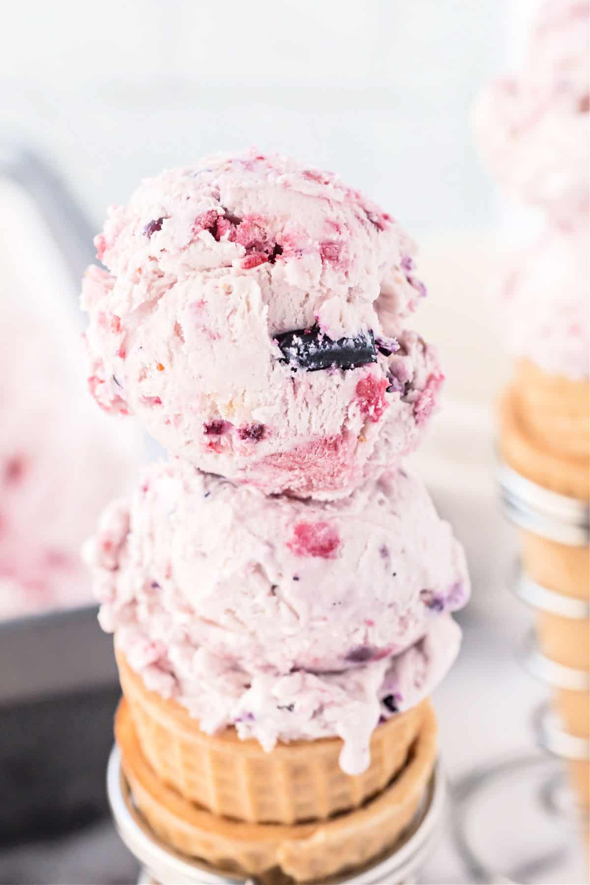 Berry ice cream scooped onto a sugar cone.
