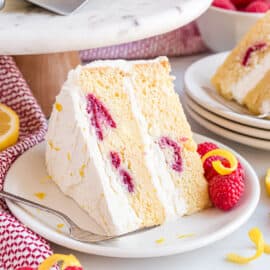 Slice of raspberry lemon cake on a white plate.