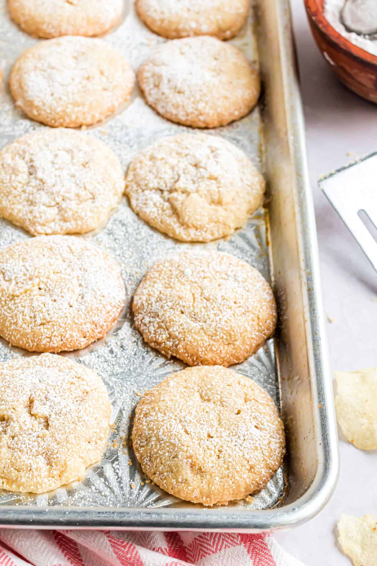 Fresh baked potato chip cookies on cookie sheet.