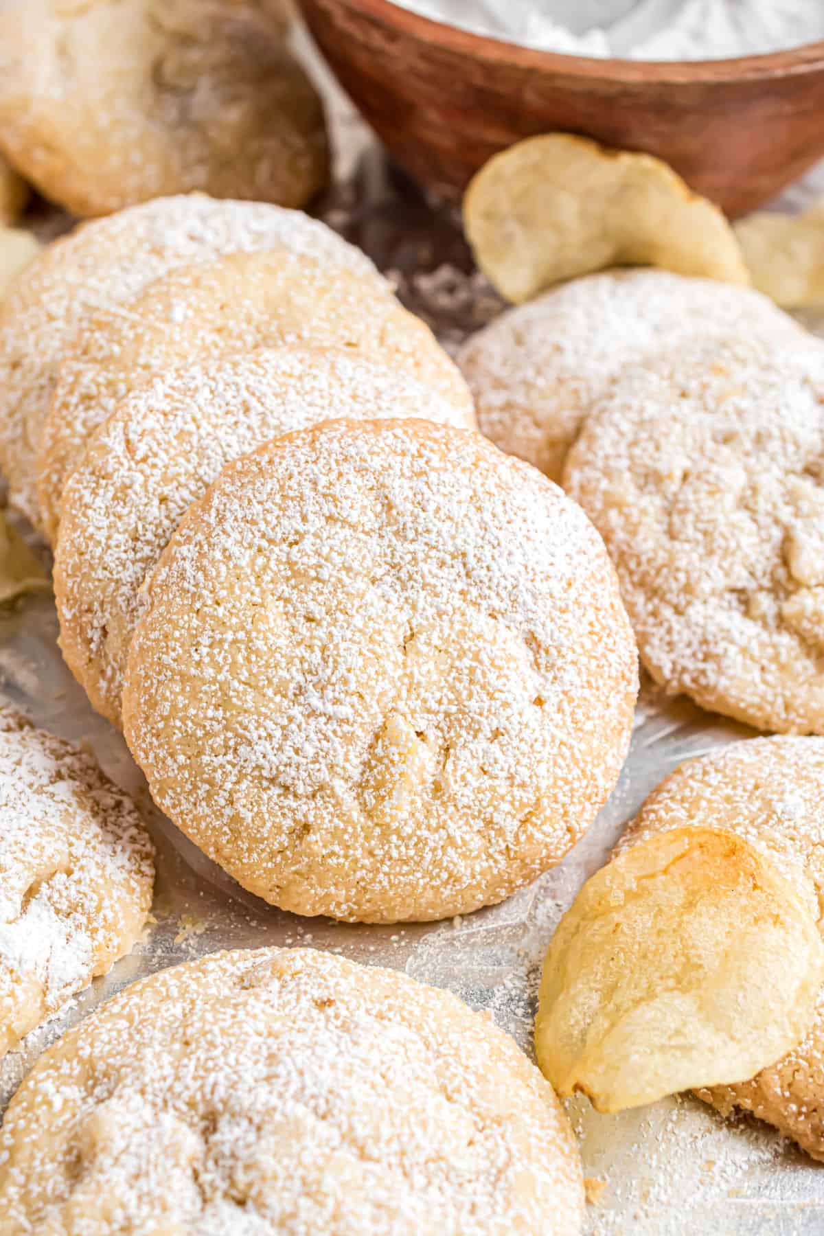 Potato chip cookies stacked on parchment paper.