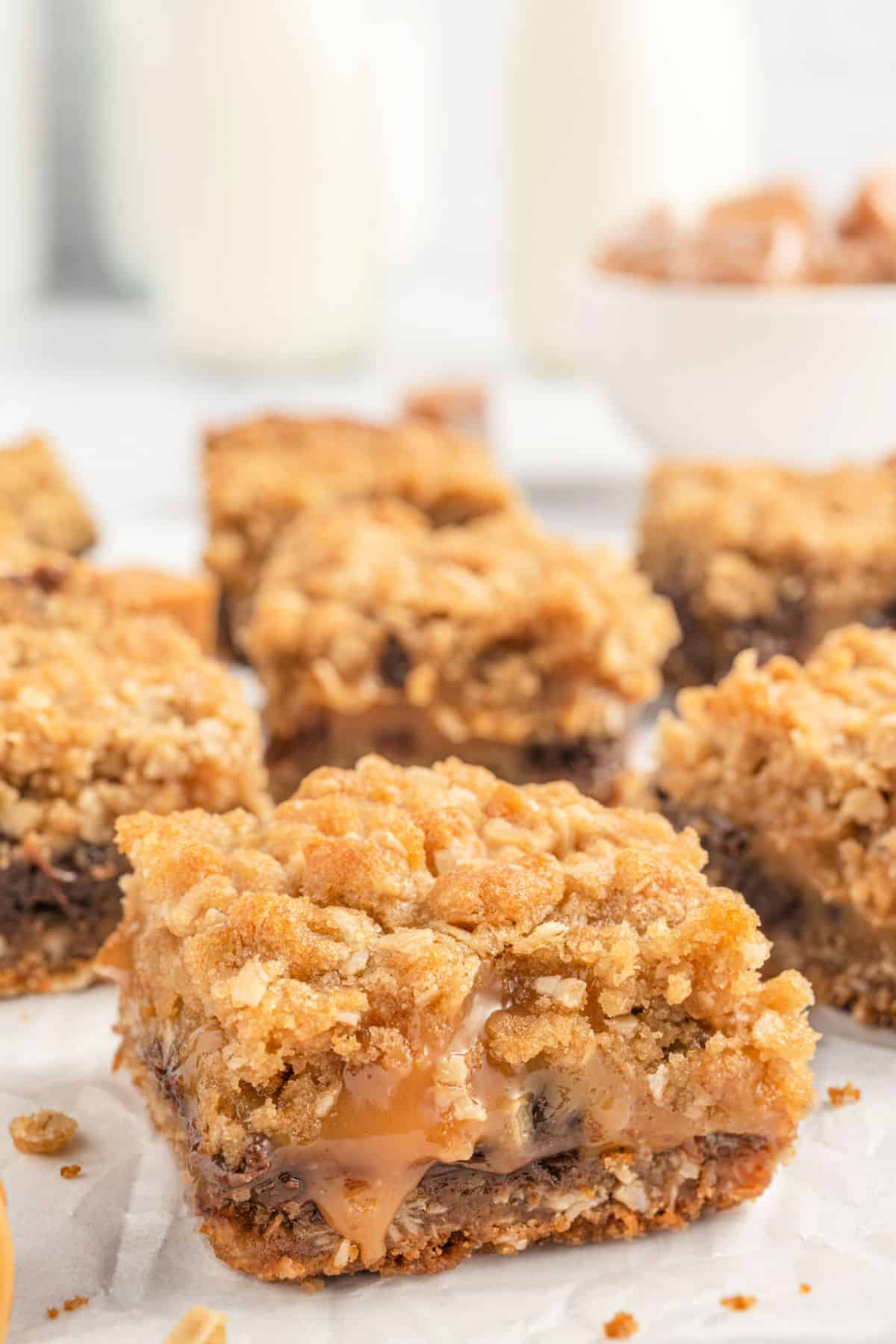 Oatmeal caramel bar with gooey filling dripping.