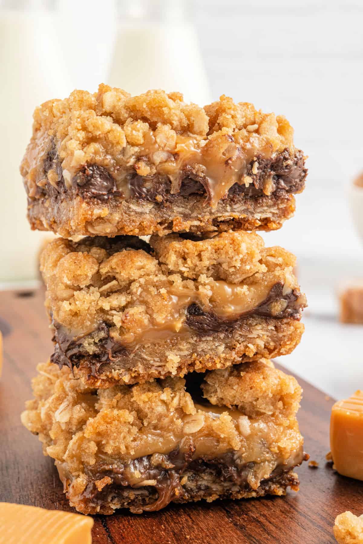 Three caramelitas stacked on a wooden board.