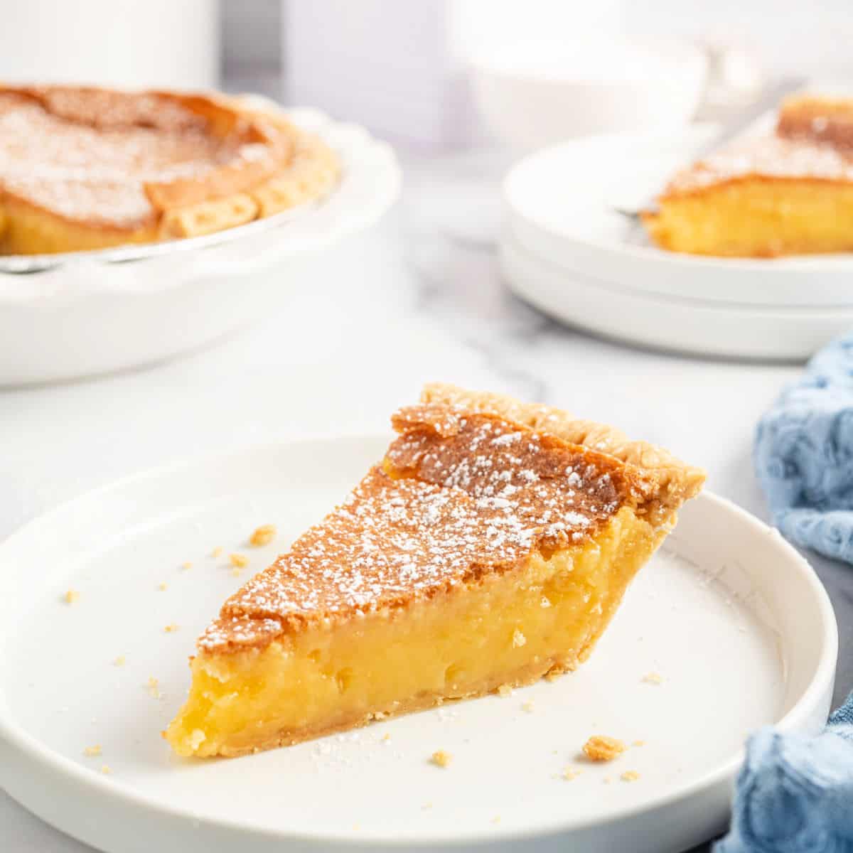 Slice of chess pie on a white plate.