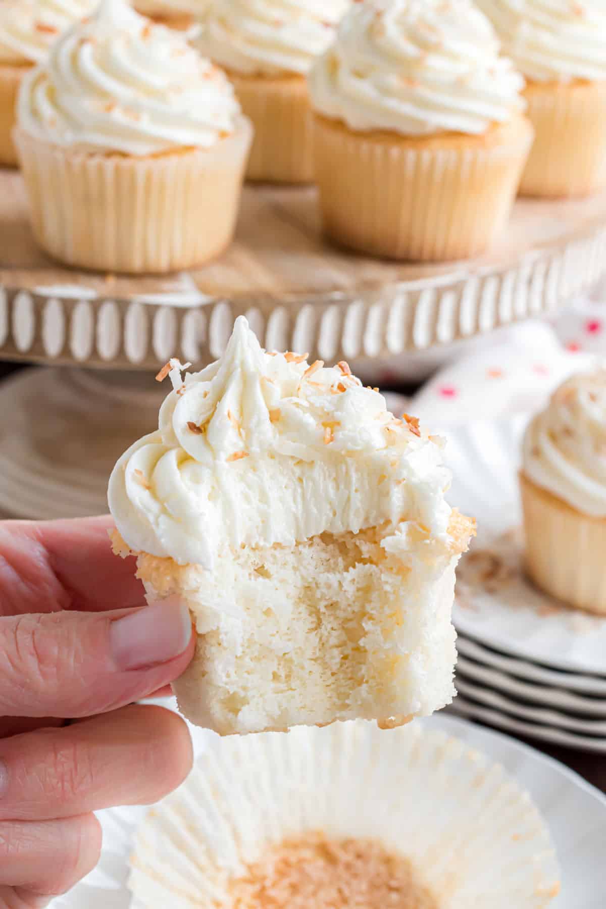 Coconut cupcake with a bite taken out.