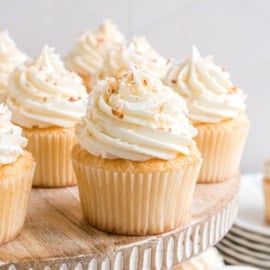 These Coconut Cupcakes are light, moist, and full of rich coconut flavor. Topped with tangy cream cheese frosting and more coconut, they’re an elegant but easy dessert that’s fit for any crowd!