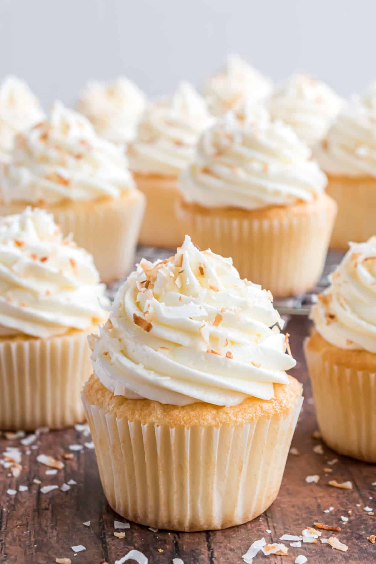 Coconut cupcake topped with cream cheese frosting.