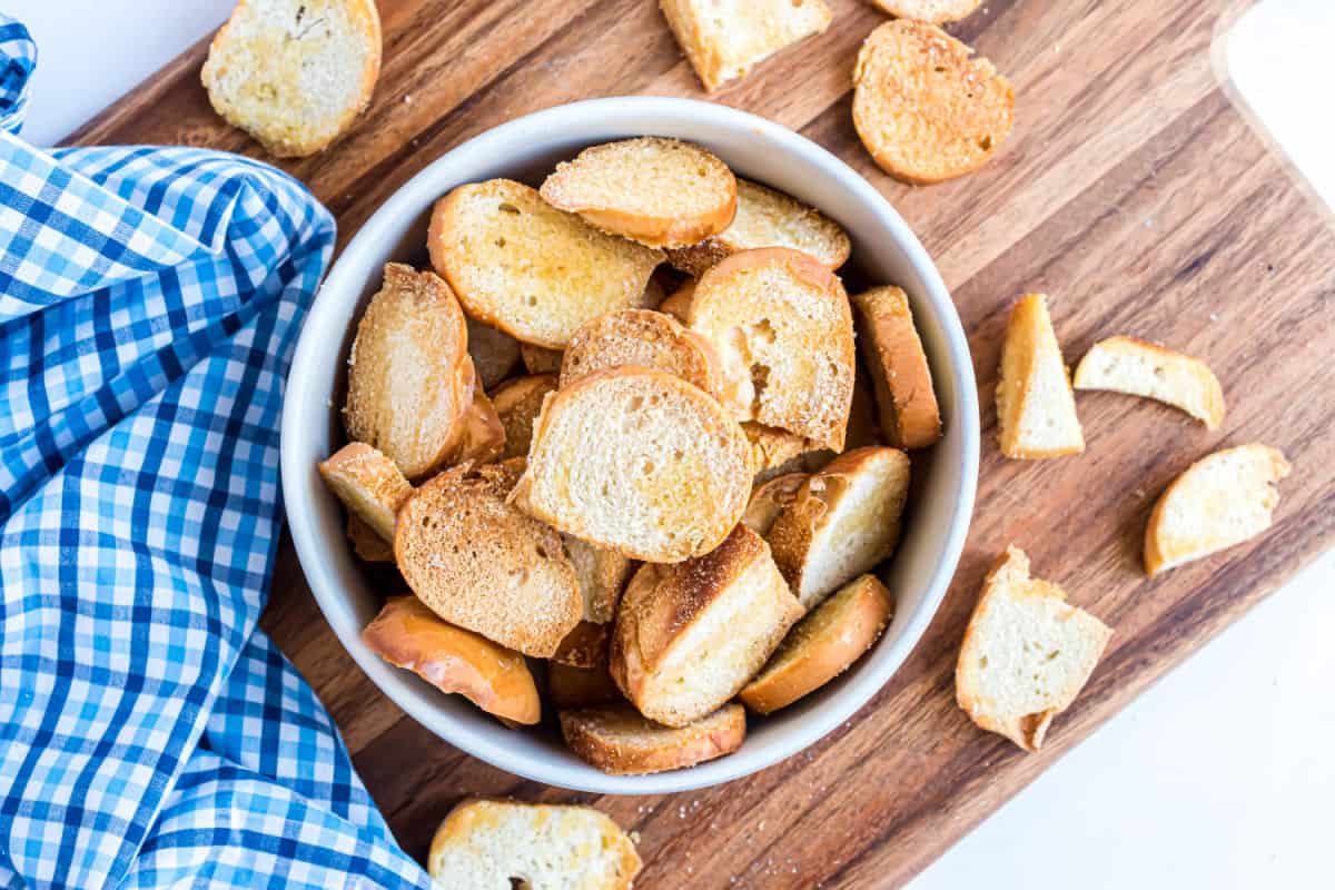 Bagel chips in a white bowl for serving.