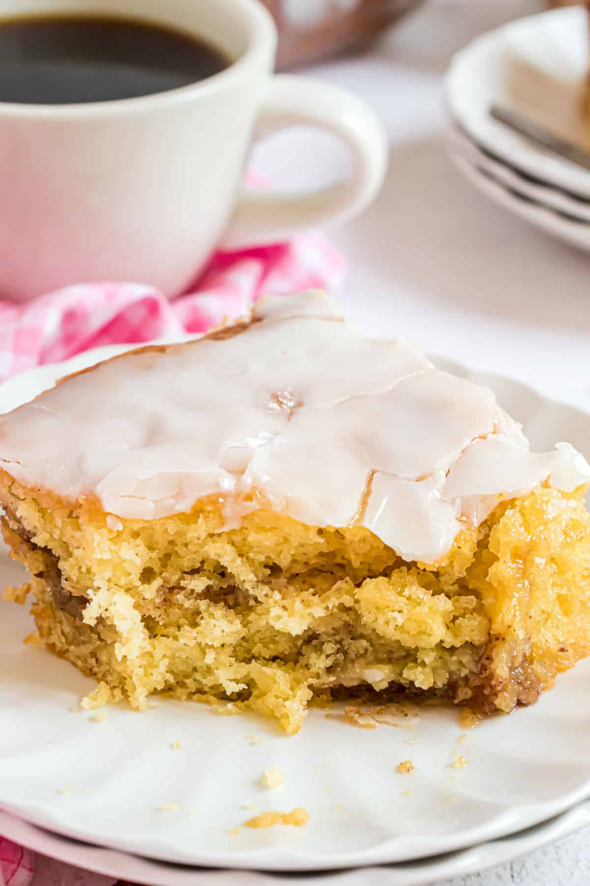 Slice of honey bun cake with a bite taken out.