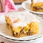 Slice of honey bun cake on a white plate.