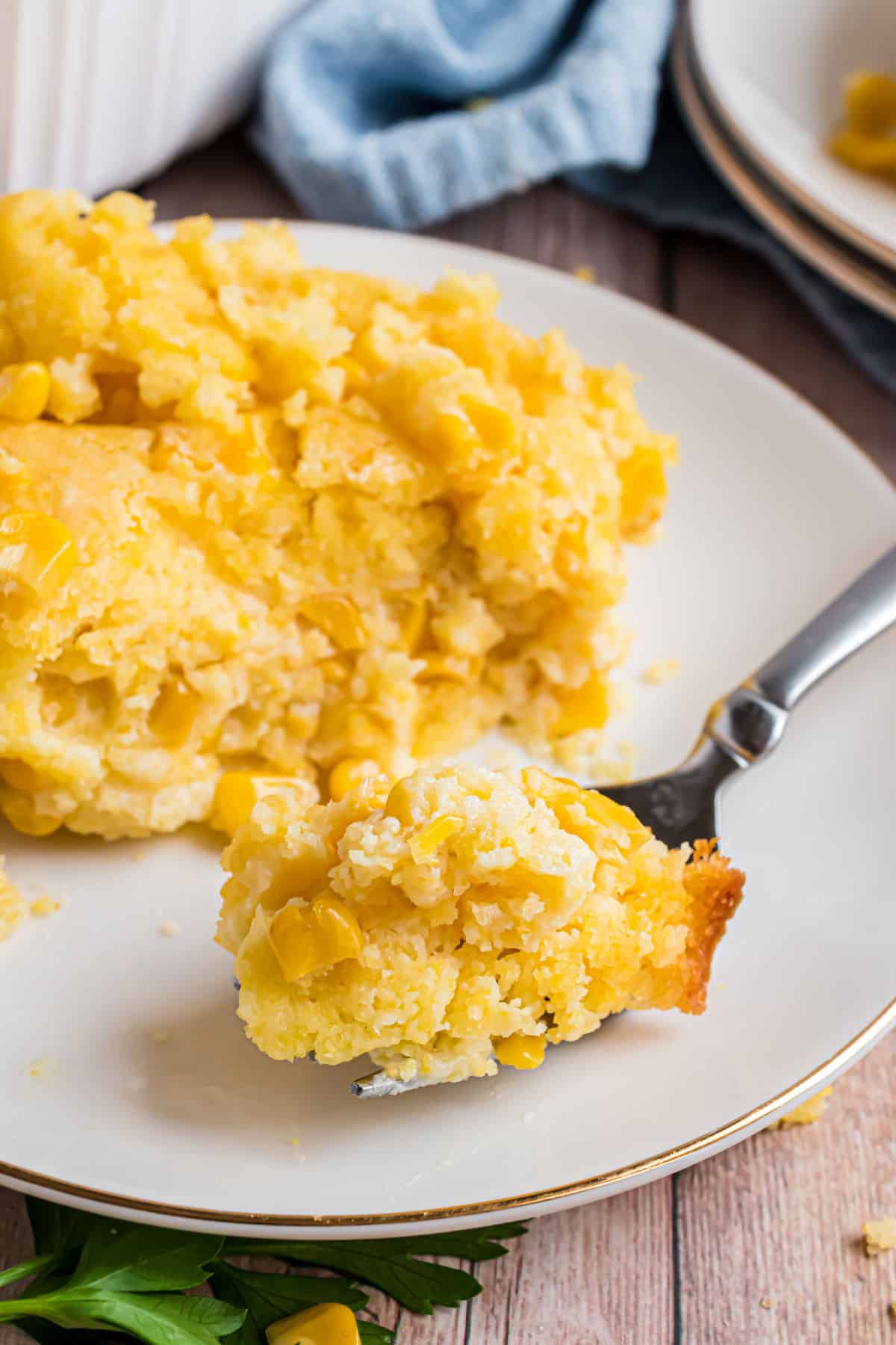 White plate with a scoop of cream corn casserole.