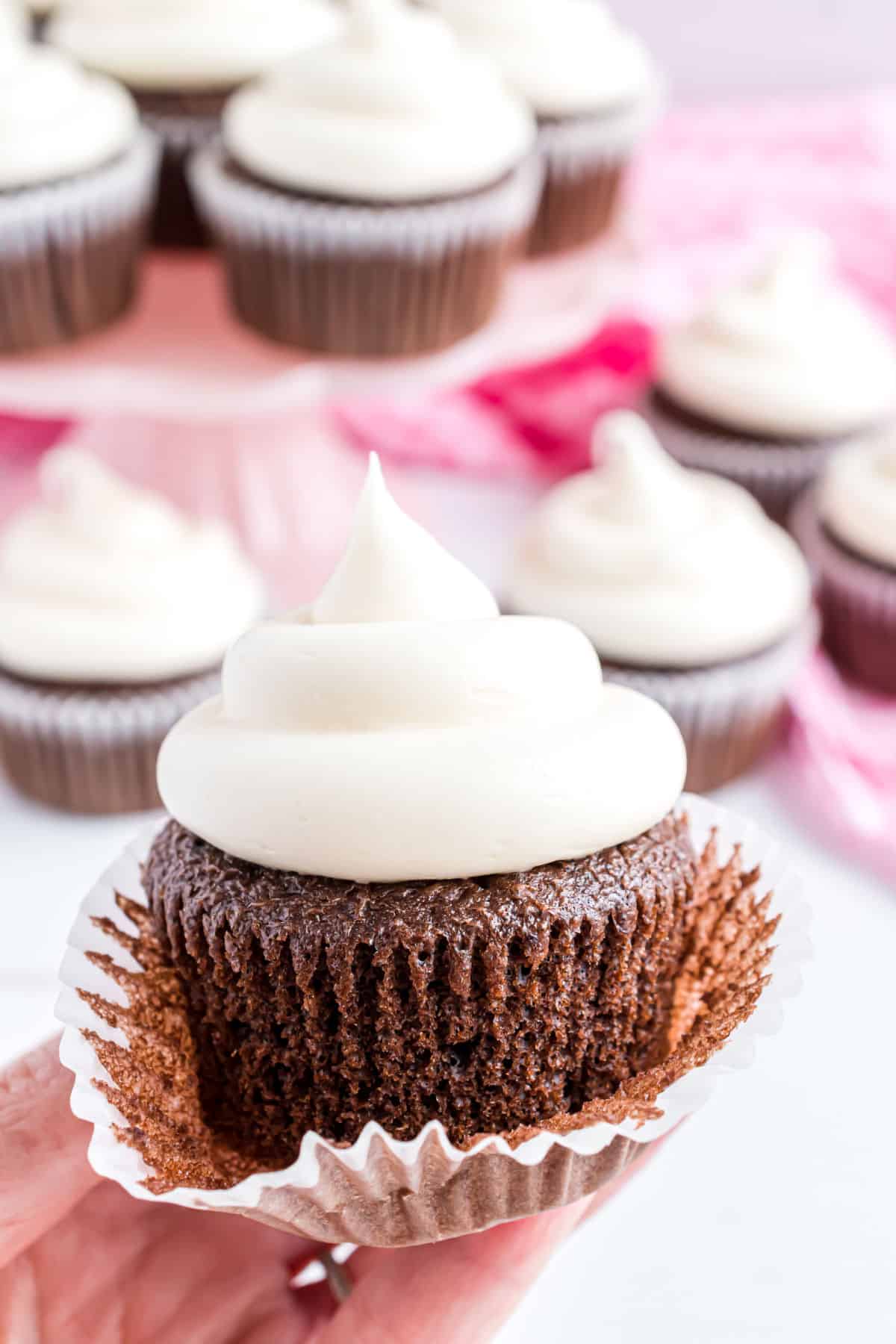 Unwrapped chocolate cupcake with a swirl of marshmallow frosting.