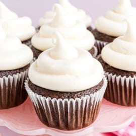Chocolate cupcakes with piped marshmallow frosting on top.