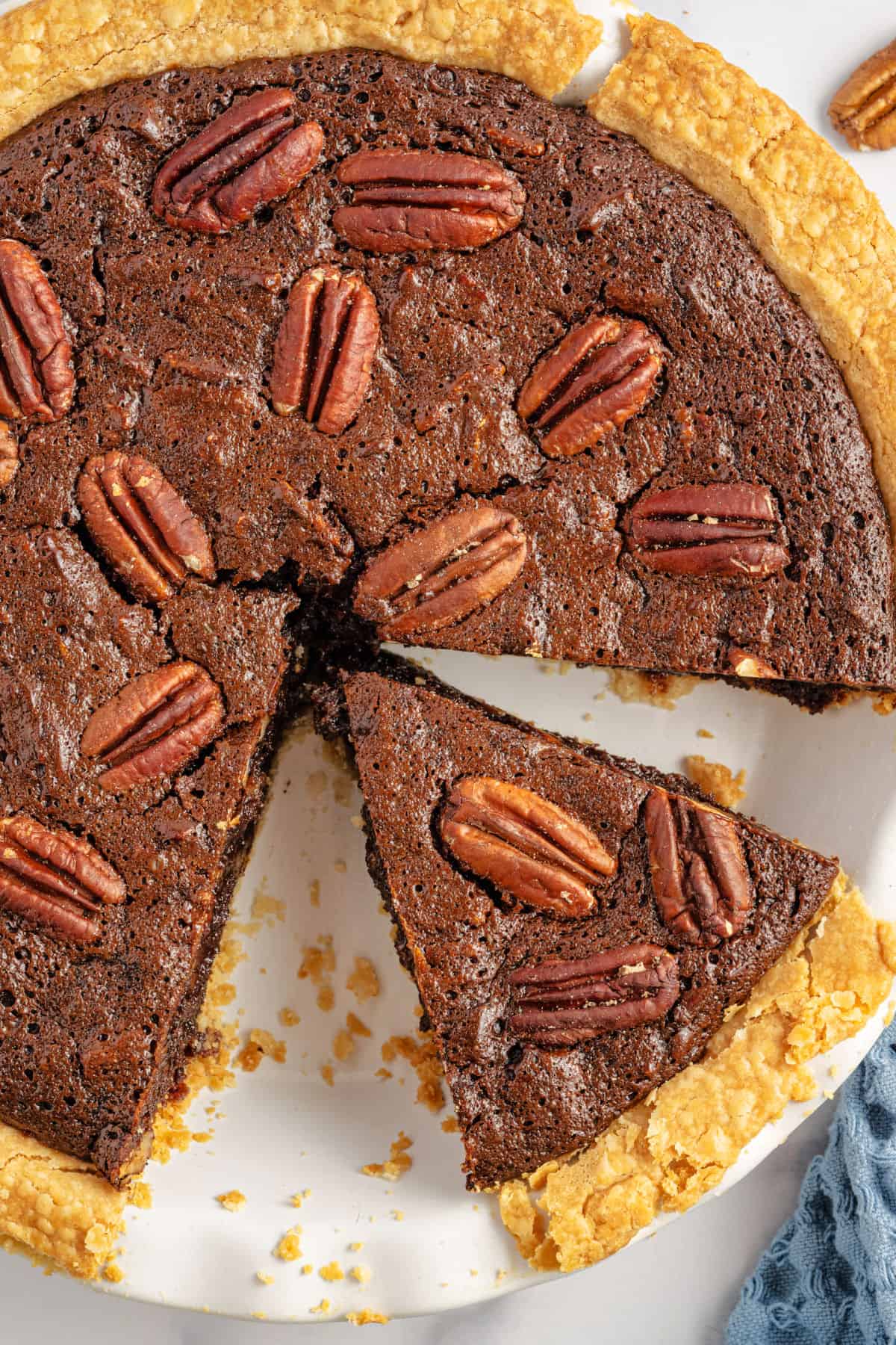 Chocolate pecan pie cut into slices.