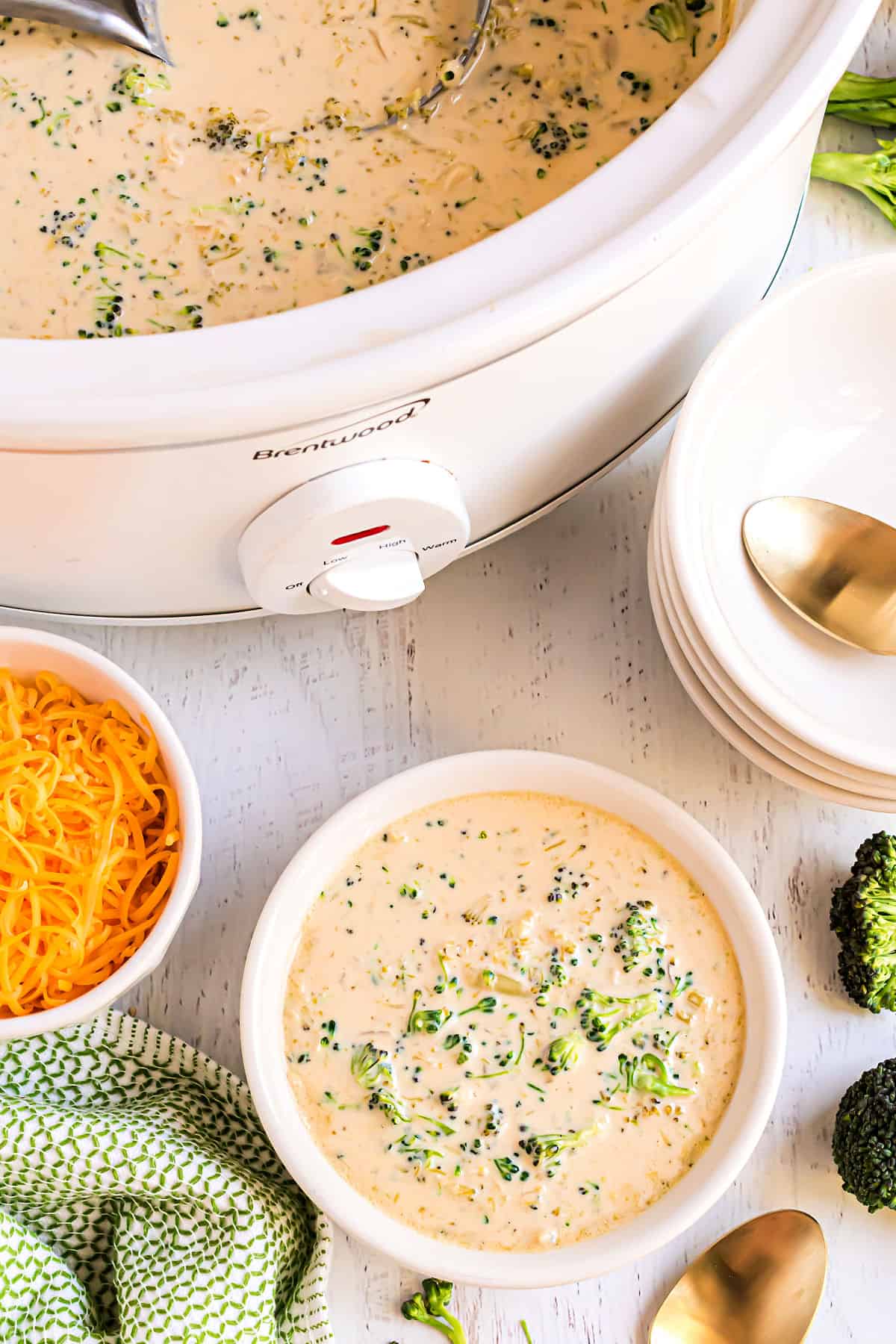 Broccoli cheese soup served in a white bowl.