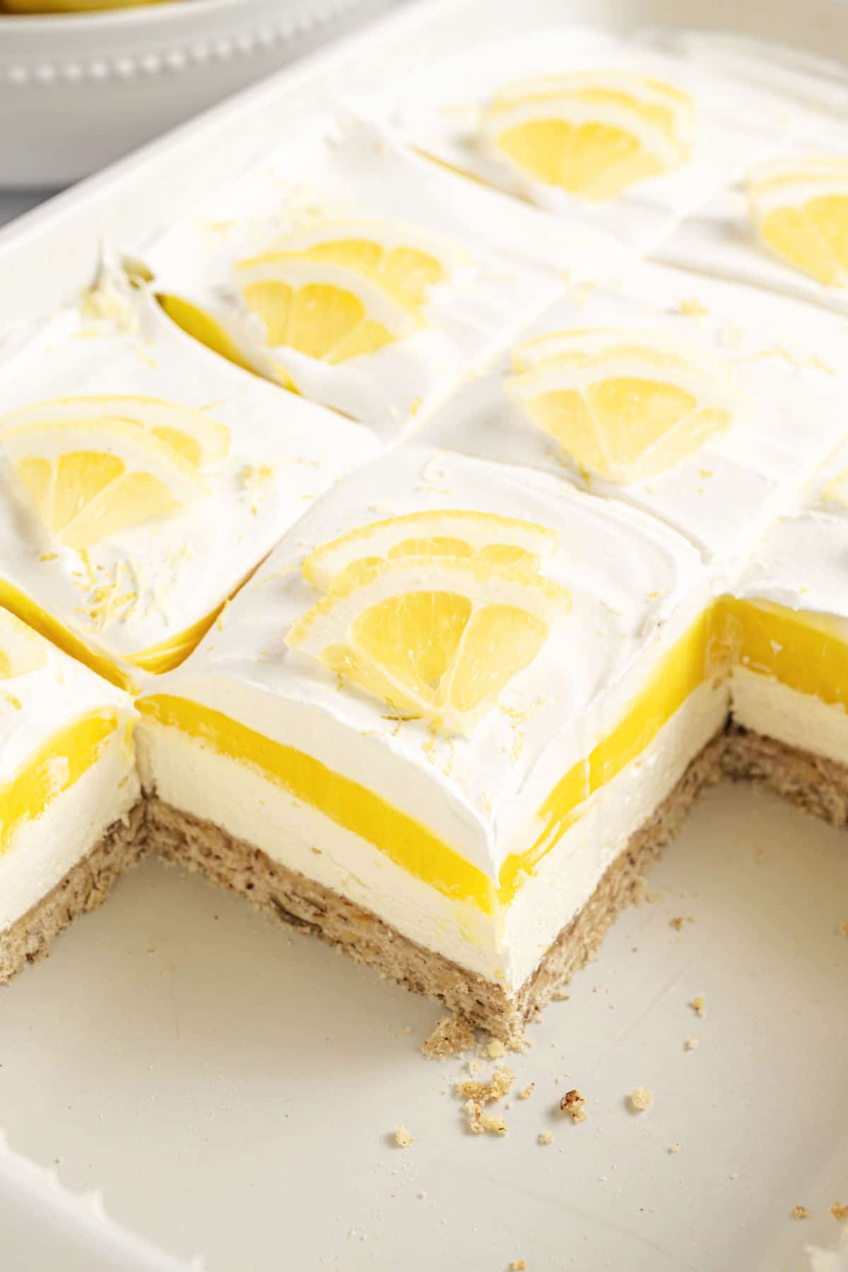 Pan of lemon lush with a few slices removed.