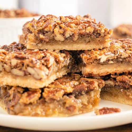 Savor the sweet life with these Pecan Pie Bars—a mere 15 minutes of prep time for a treat that tastes like a labor of love. If you love pecan pie, why not bake a batch of these gooey bars instead!